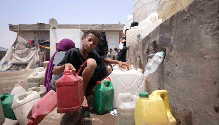 Displaced child at water point [1]