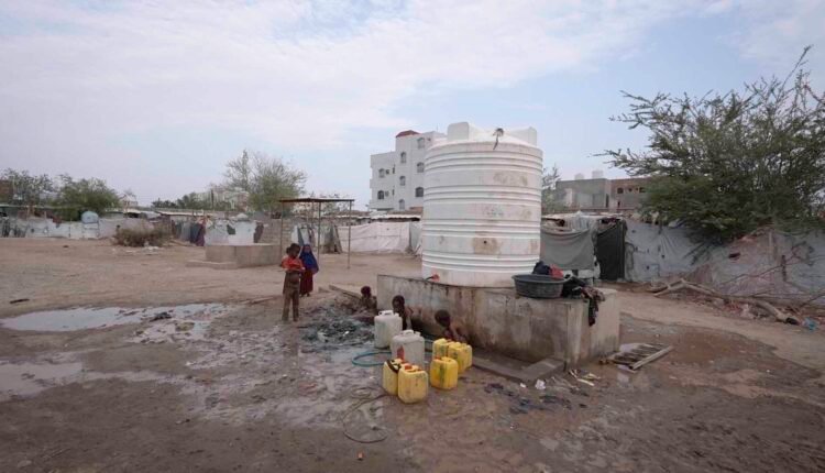 Displaced children at water point [Wide]