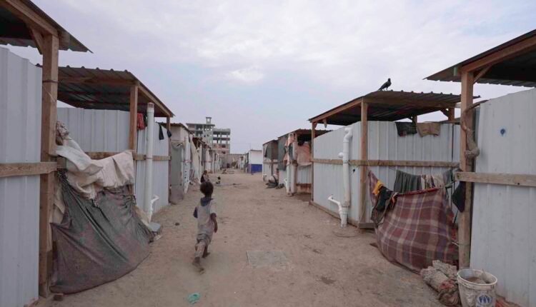 Moving shot inside displacement camp [Wide]