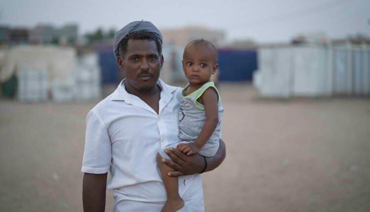 Displaced father with his child