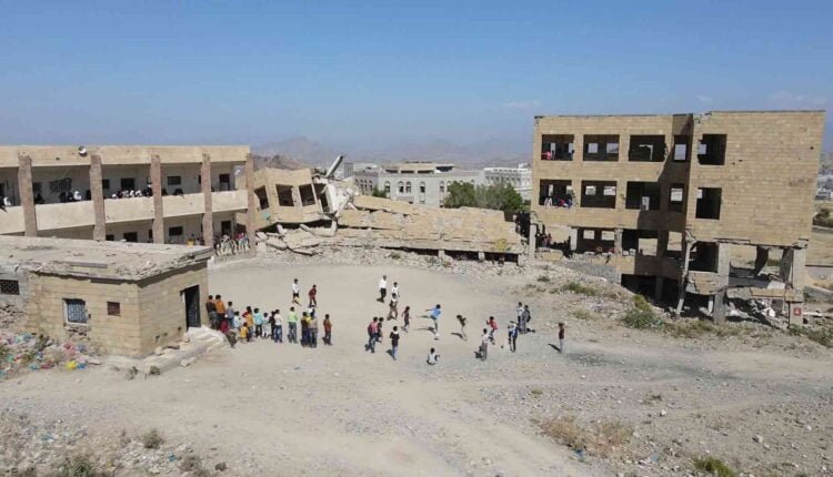 Playing football at the yard of a destroyed school [Drone]