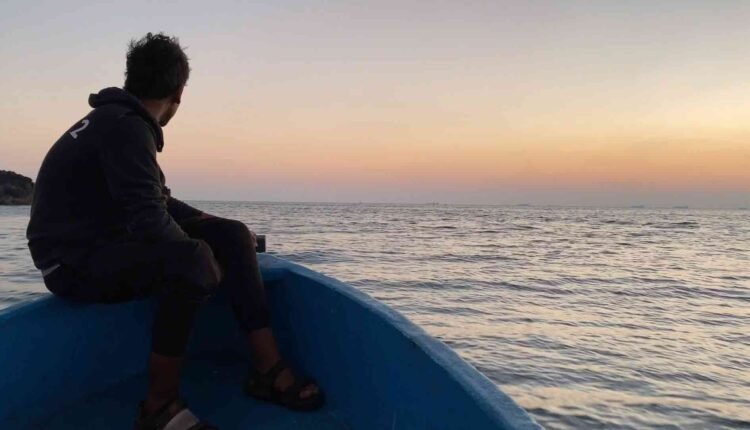 Fisherman at Boat During Sunset