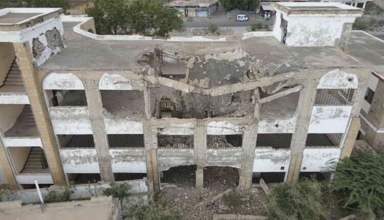 Playing football at the yard of a destroyed school [Drone] [4]