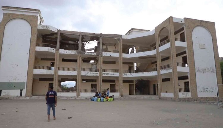 Playing football at the yard of a destroyed school