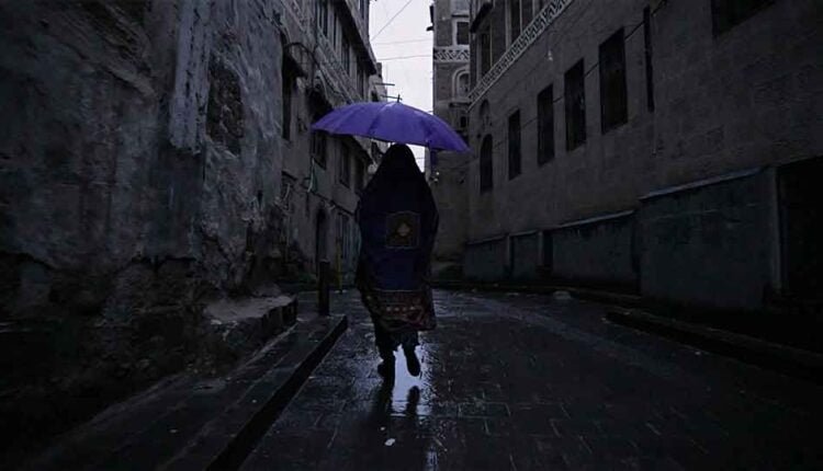 Woman walking under the rain