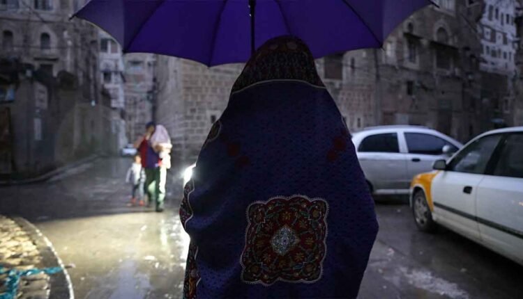 Woman walking under the rain [2]