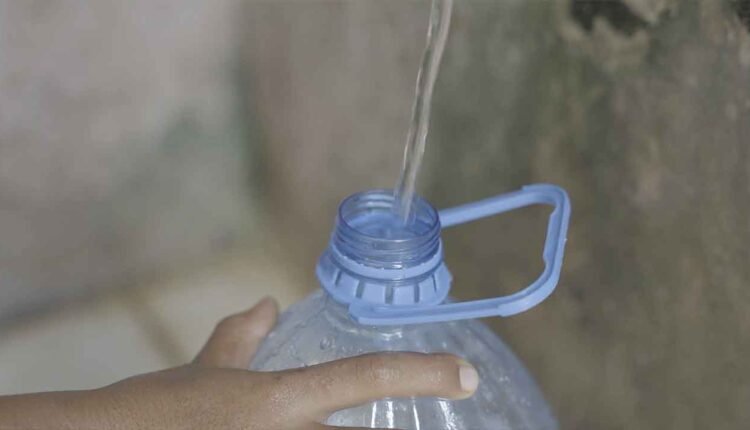 Filling a bottle with water