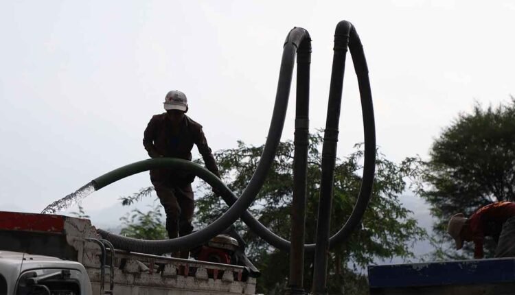 Filling up a water truck [6]